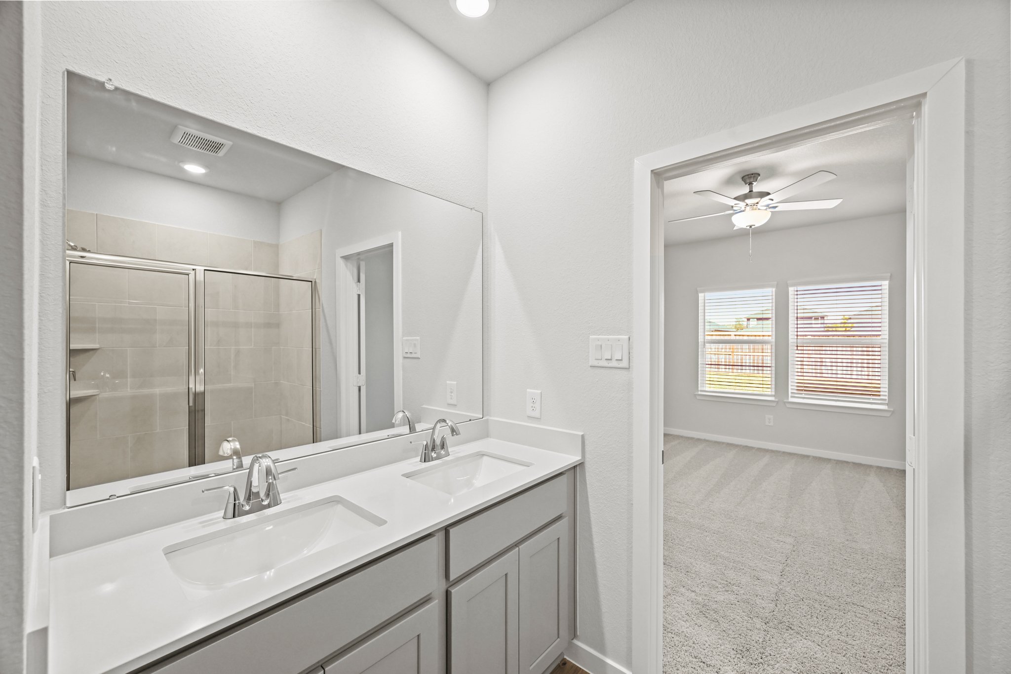 A bathroom with a large mirror.