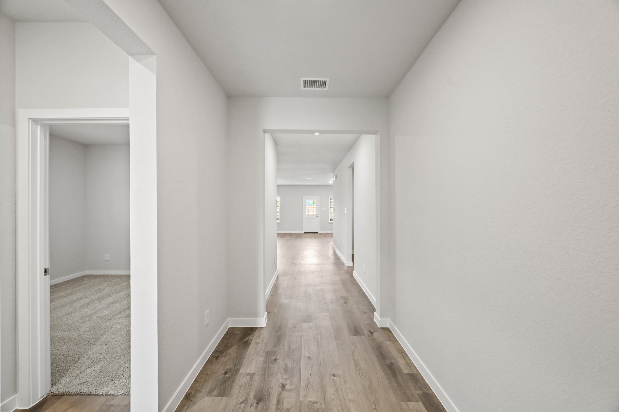 A long hallway with white walls.
