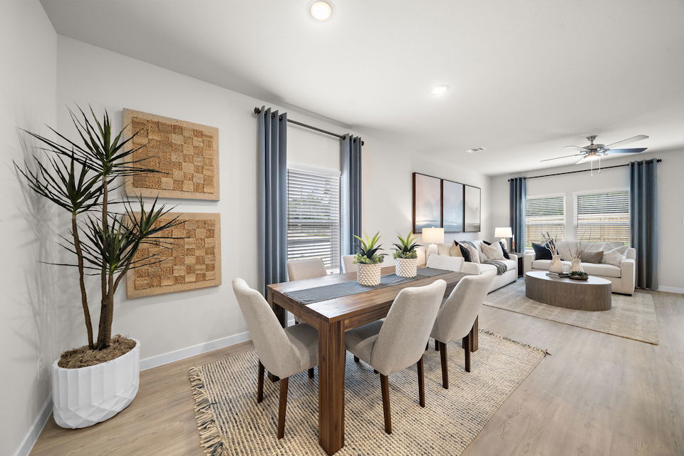 A dining room with a large table.