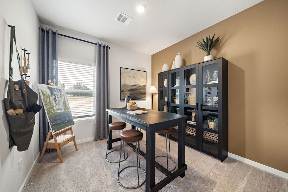 A room with a table and chairs.