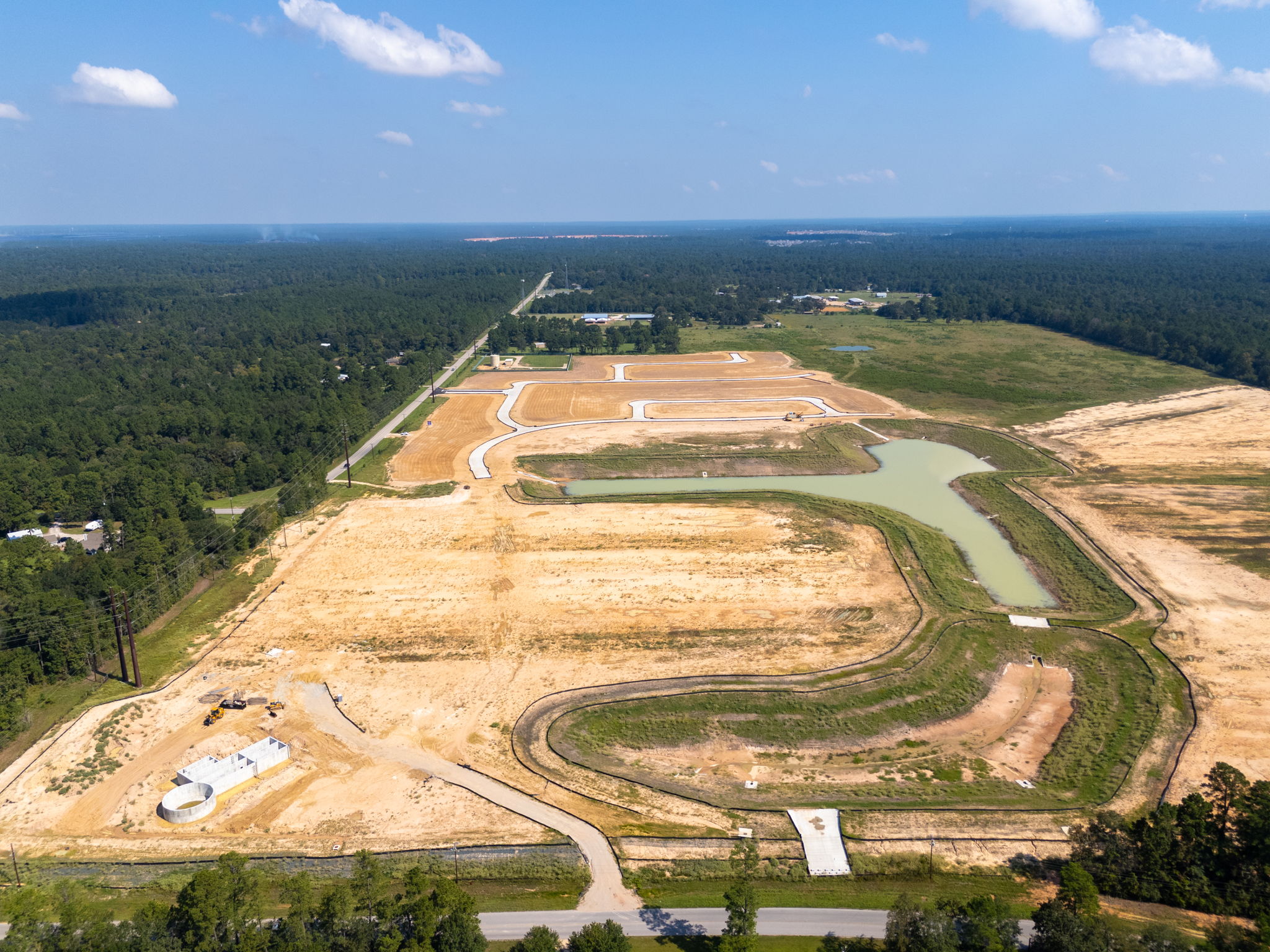 A large area of land with a body of water in the background with Lookout Mountain in the background.