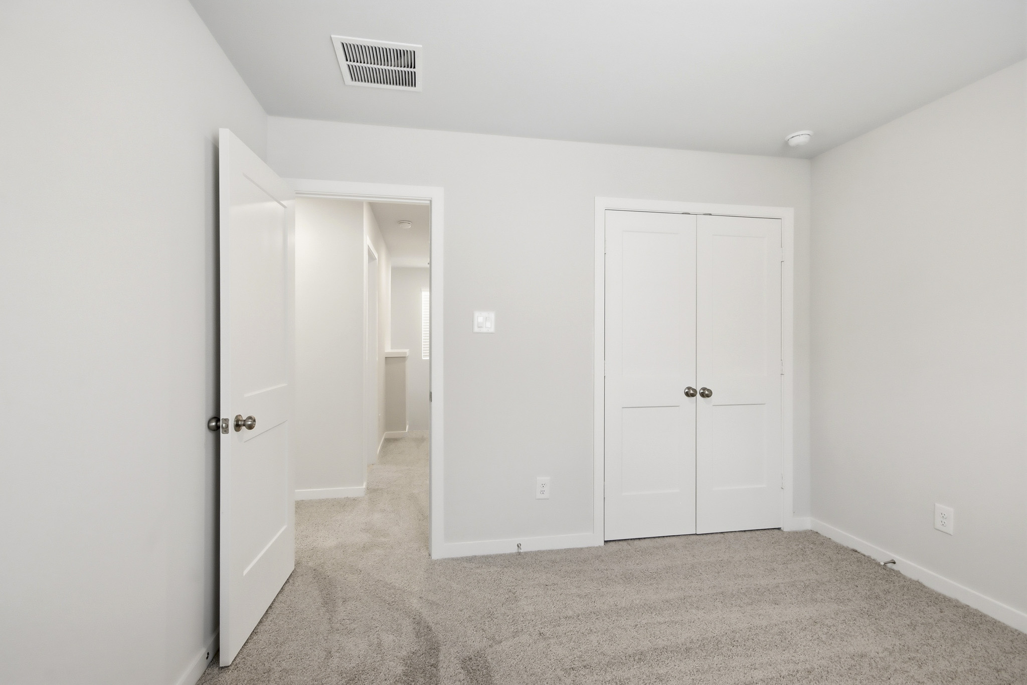 A hallway with white doors.