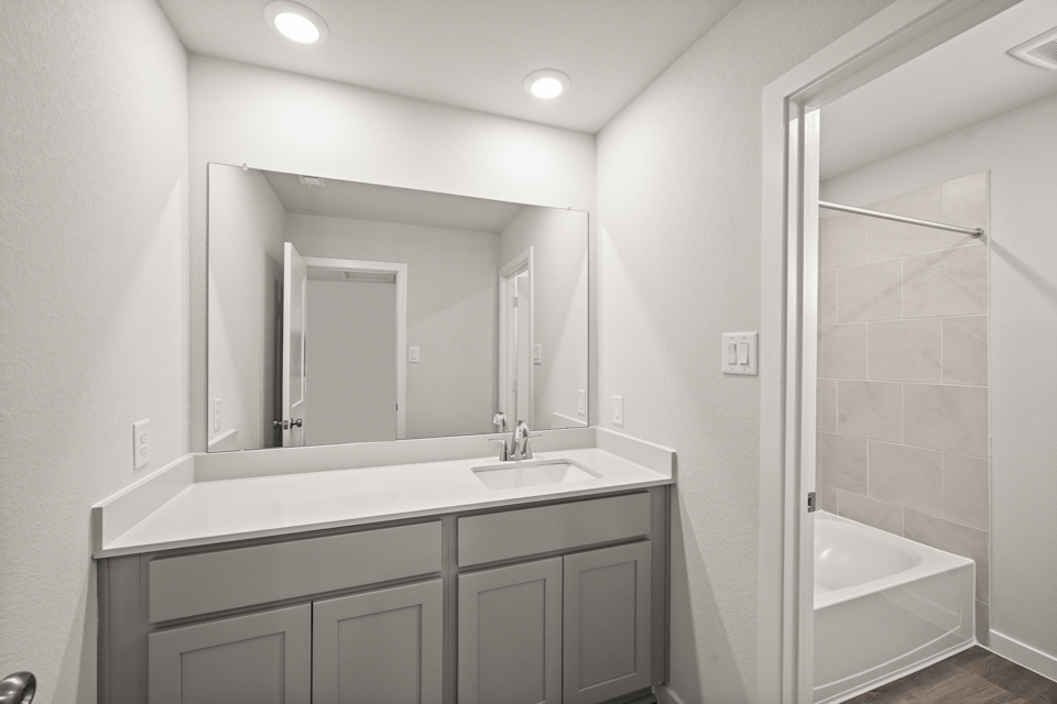 A bathroom with a sink and a bathtub.
