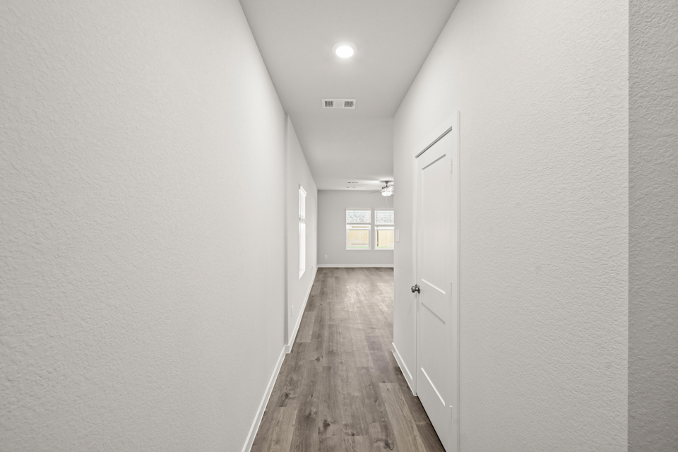 A hallway with white doors.