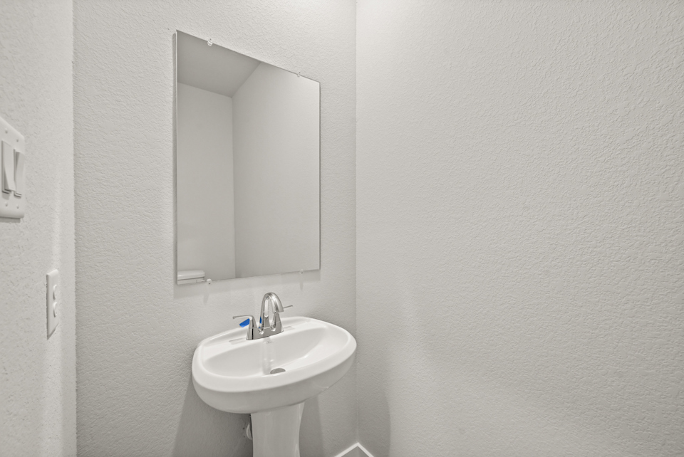 A bathroom with a mirror and sink.