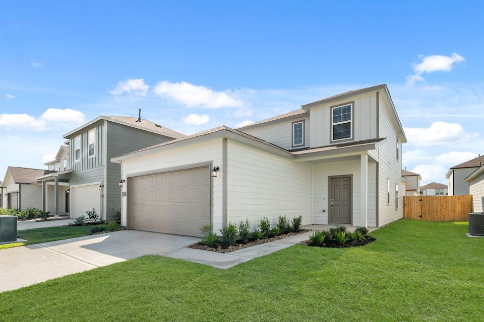 A house with a garage with Vitra Design Museum in the background.