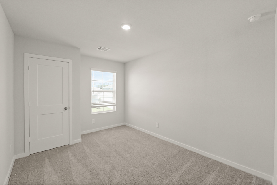 A room with a door and a window.