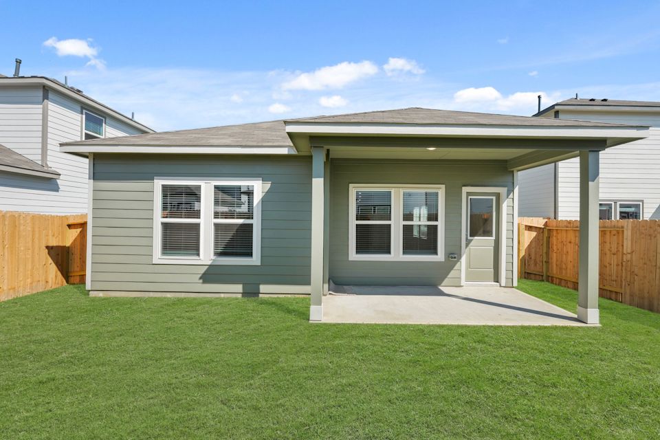 A house with a fence and grass.