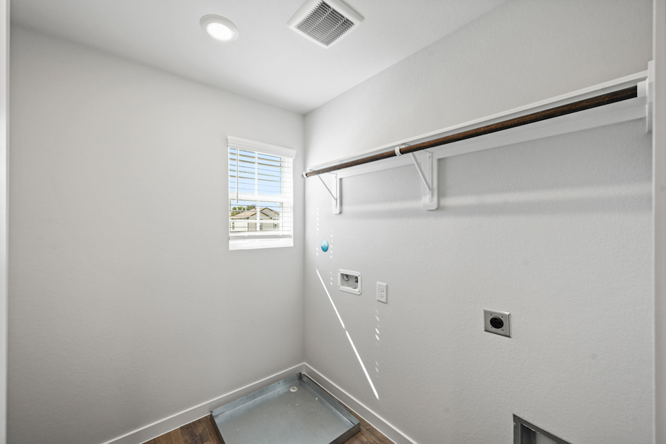 A room with a window and a metal bar.