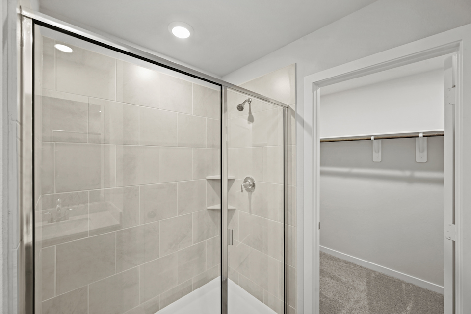 A shower with a glass door.