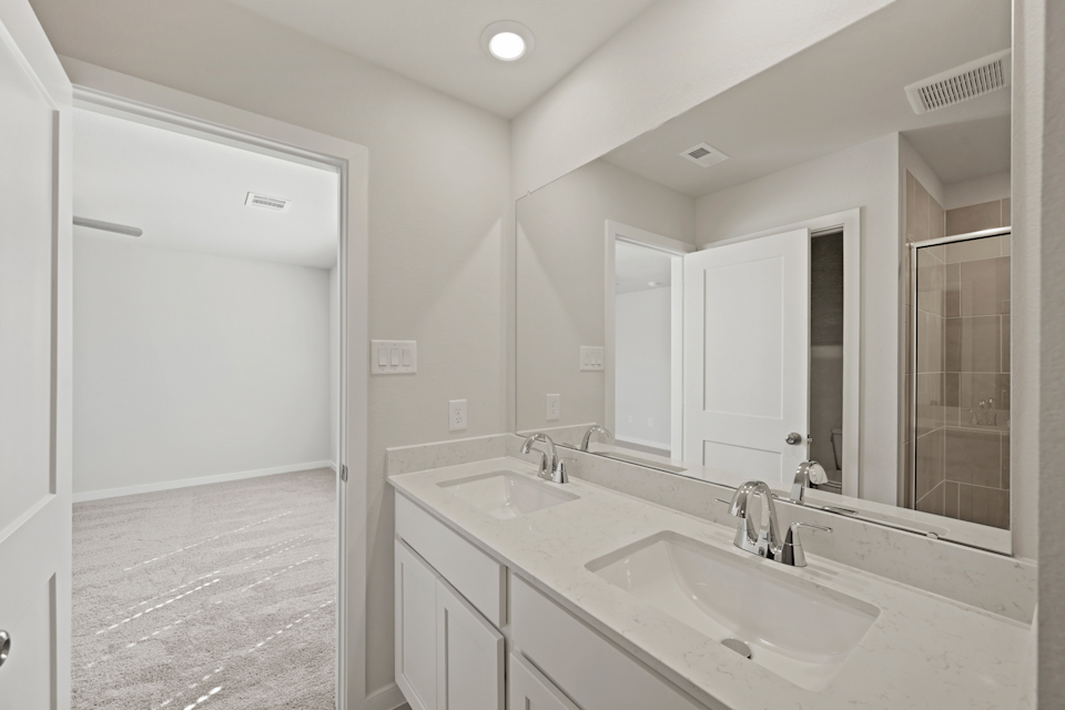 A bathroom with a large mirror.