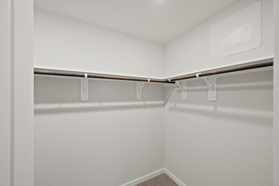 A white wall with a metal bar.