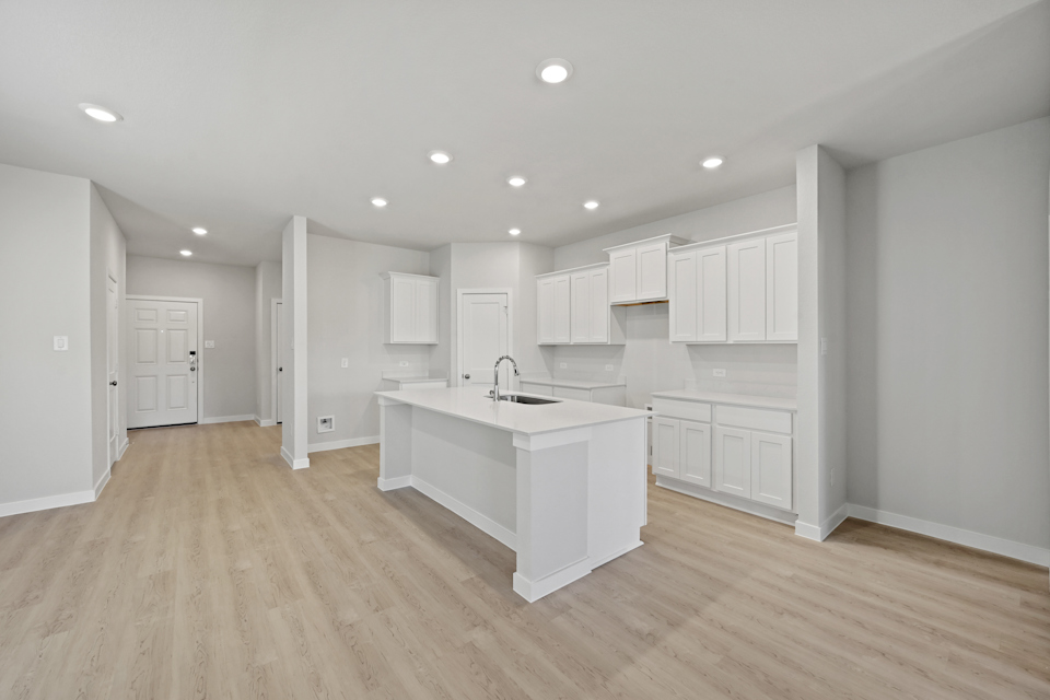 A kitchen with white cabinets.