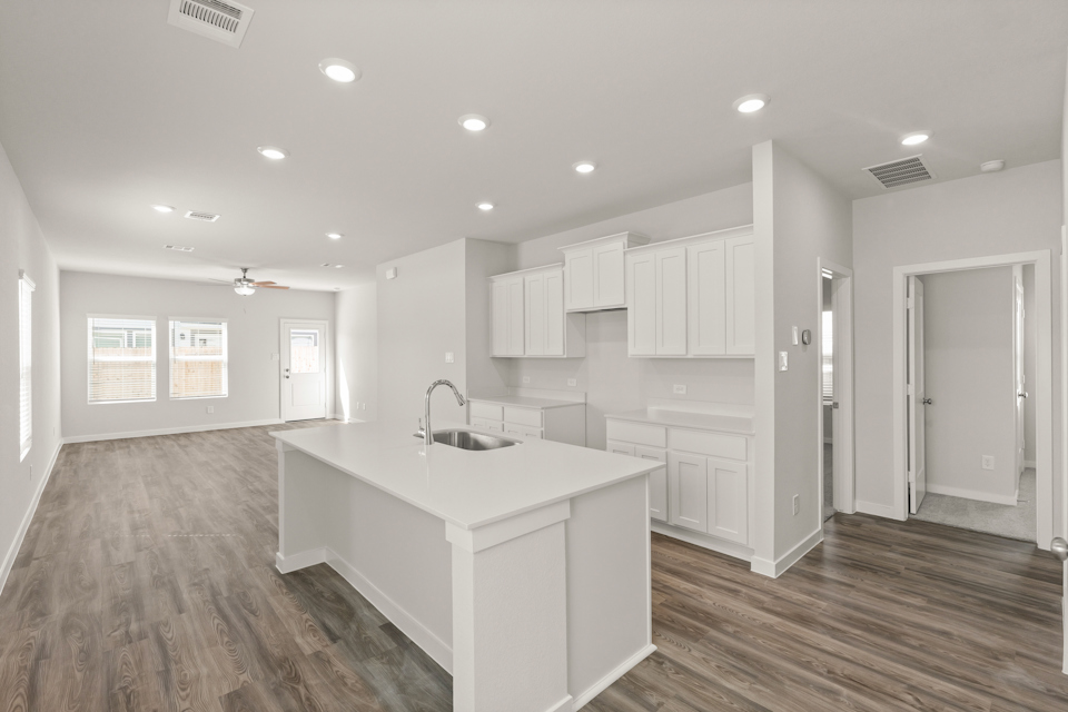 A kitchen with white cabinets.