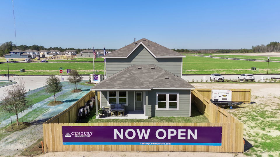 A house with a sign in front of it.