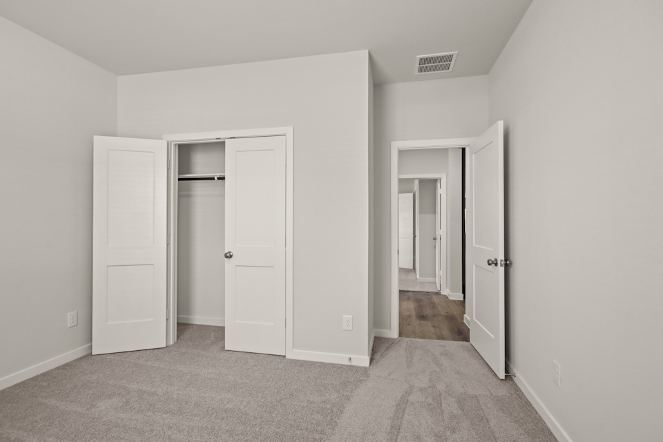 A hallway with white doors.