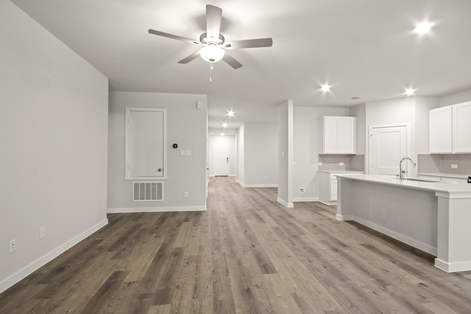 A kitchen with white cabinets.