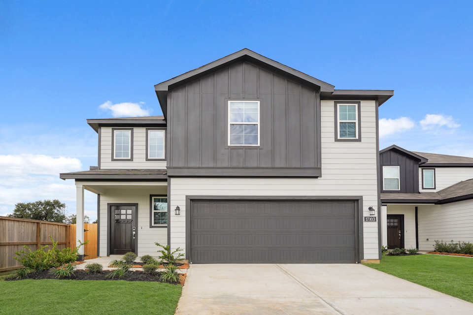 A grey house with a garage.