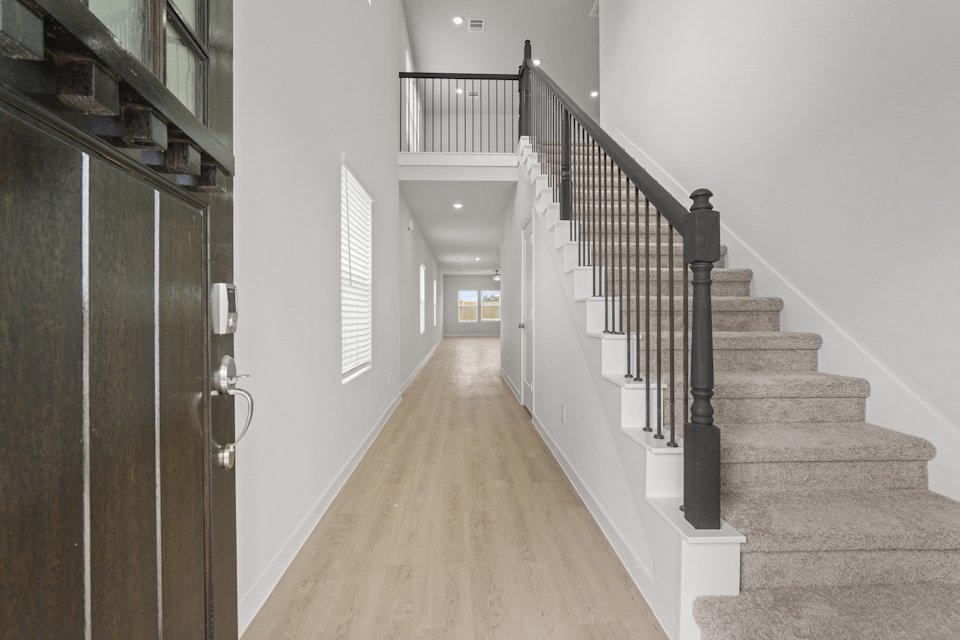 A long hallway with a wood railing.