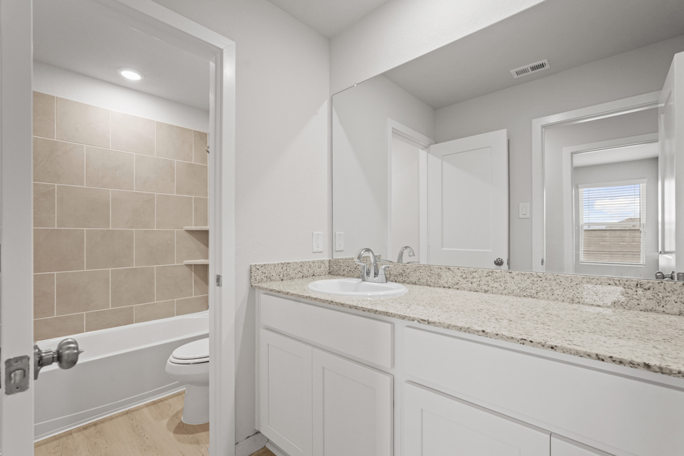 A bathroom with a marble countertop.
