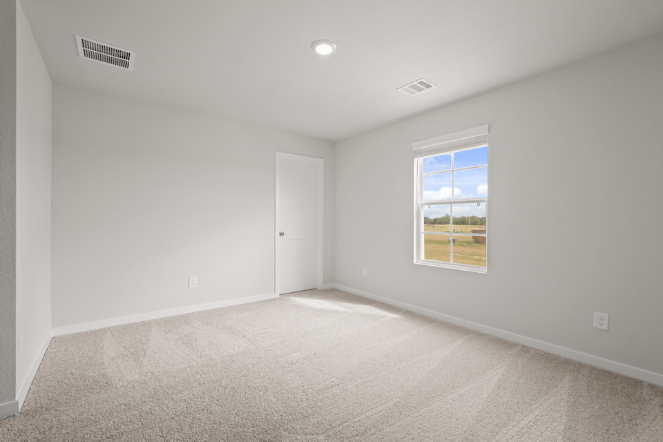 A room with a window and a door.