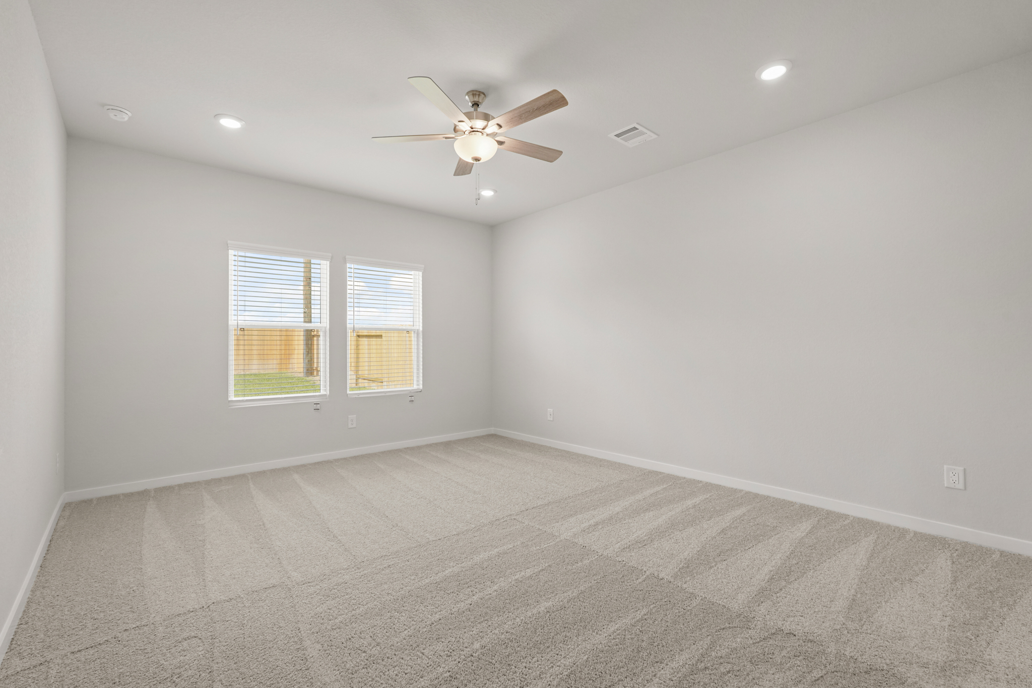 A room with a ceiling fan and a ceiling fan.