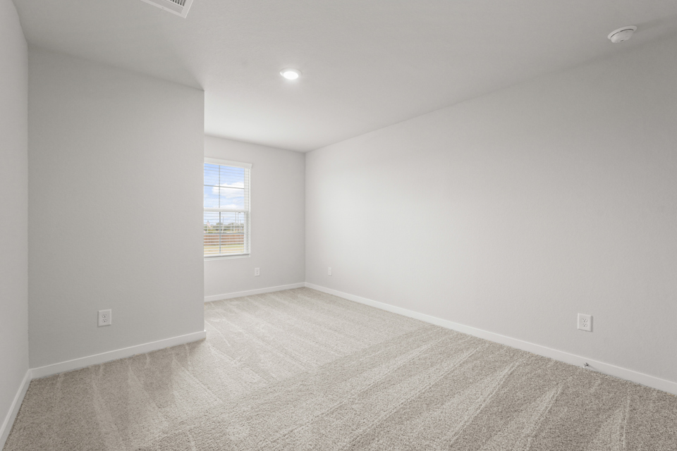 A room with a window and a carpet.