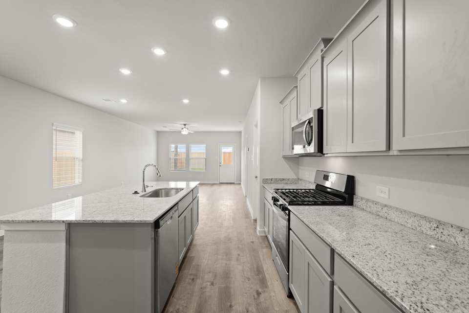 A kitchen with marble counters.