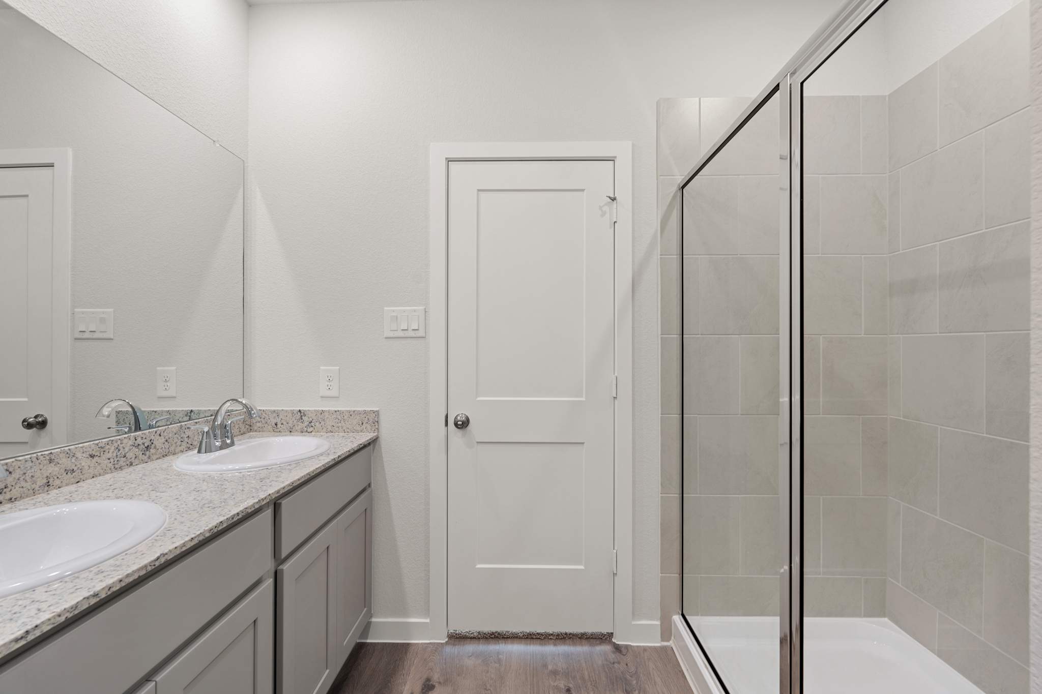 A bathroom with a shower and sink.