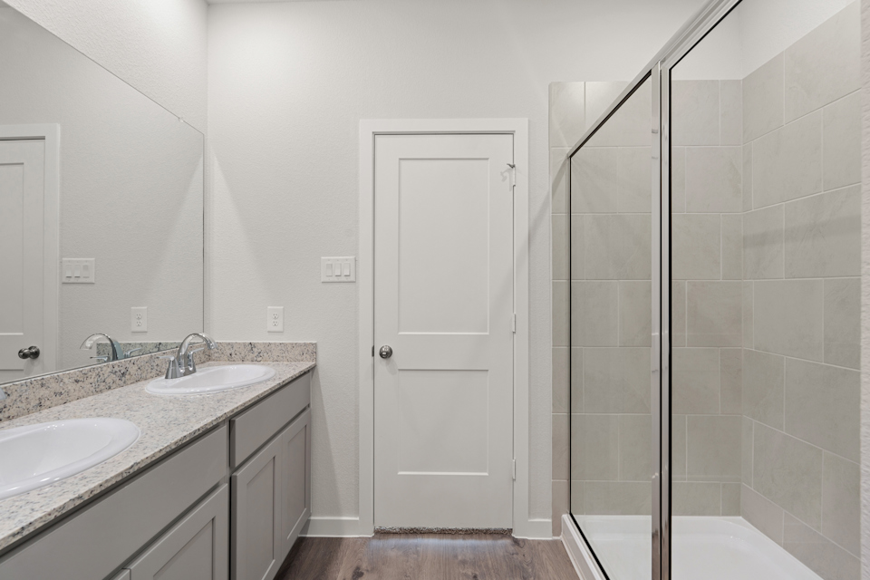 A bathroom with a shower and sink.