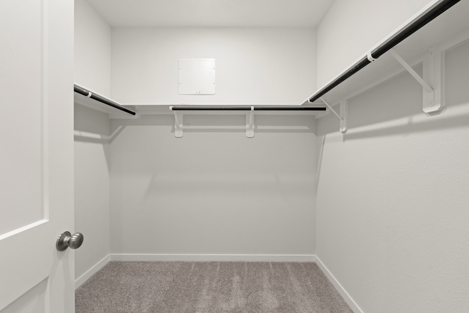 A white room with a grey carpet.