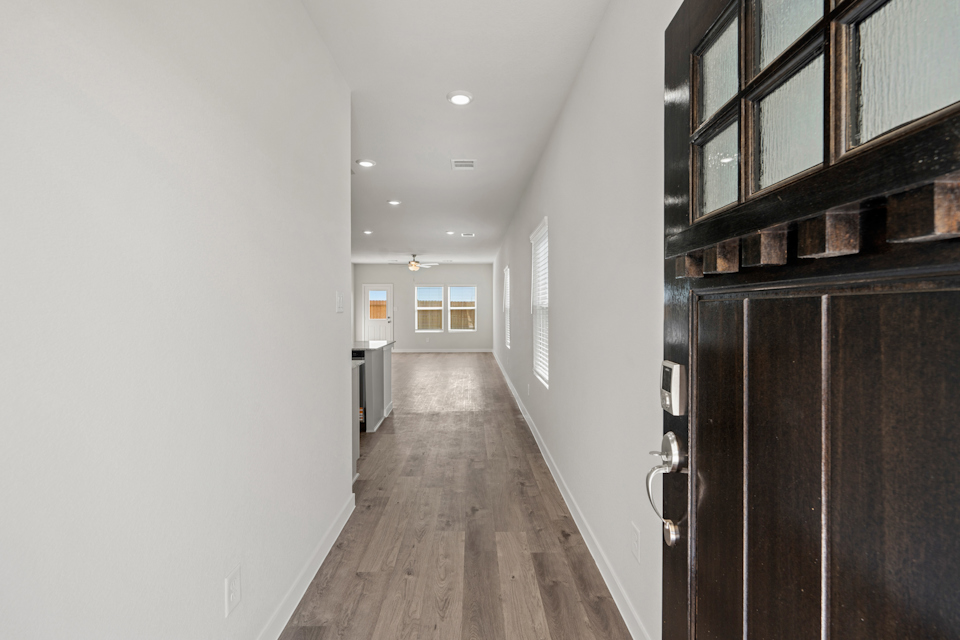 A hallway with black cabinets.