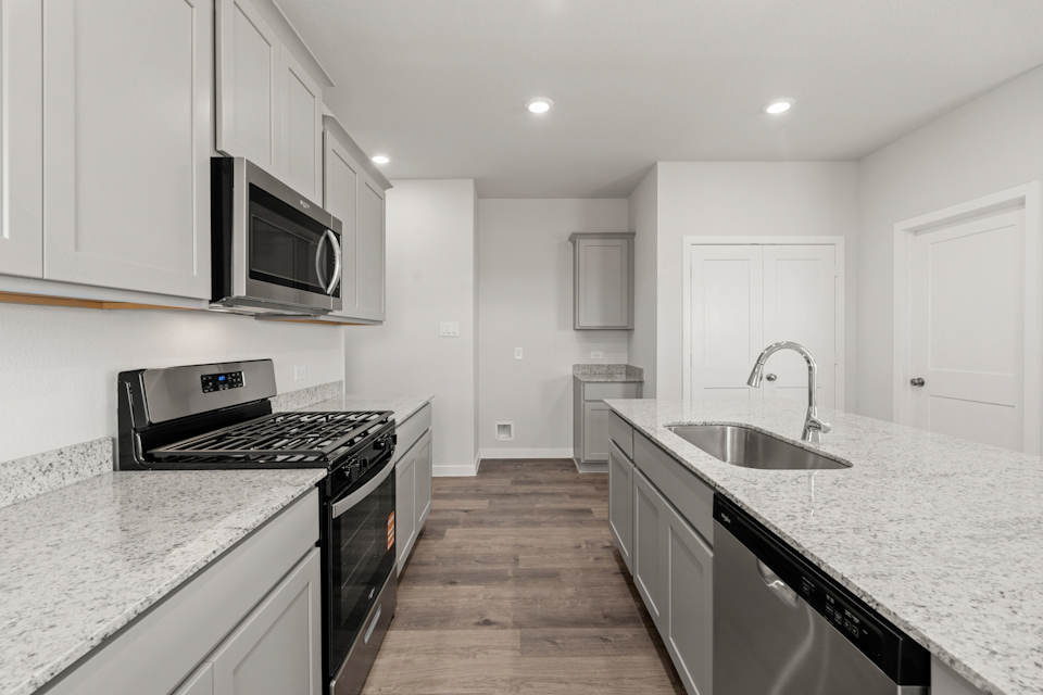 A kitchen with white cabinets.