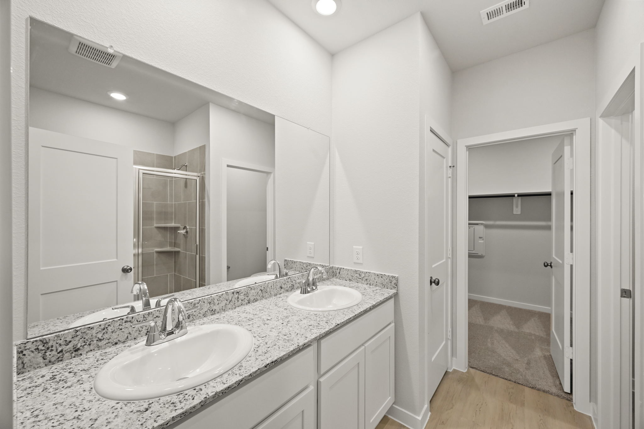 A bathroom with a large mirror.