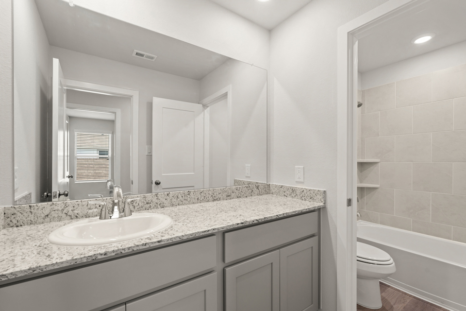 A bathroom with a marble countertop.