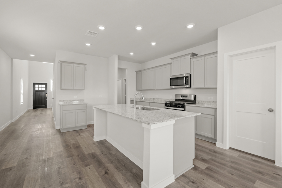 A kitchen with white cabinets.