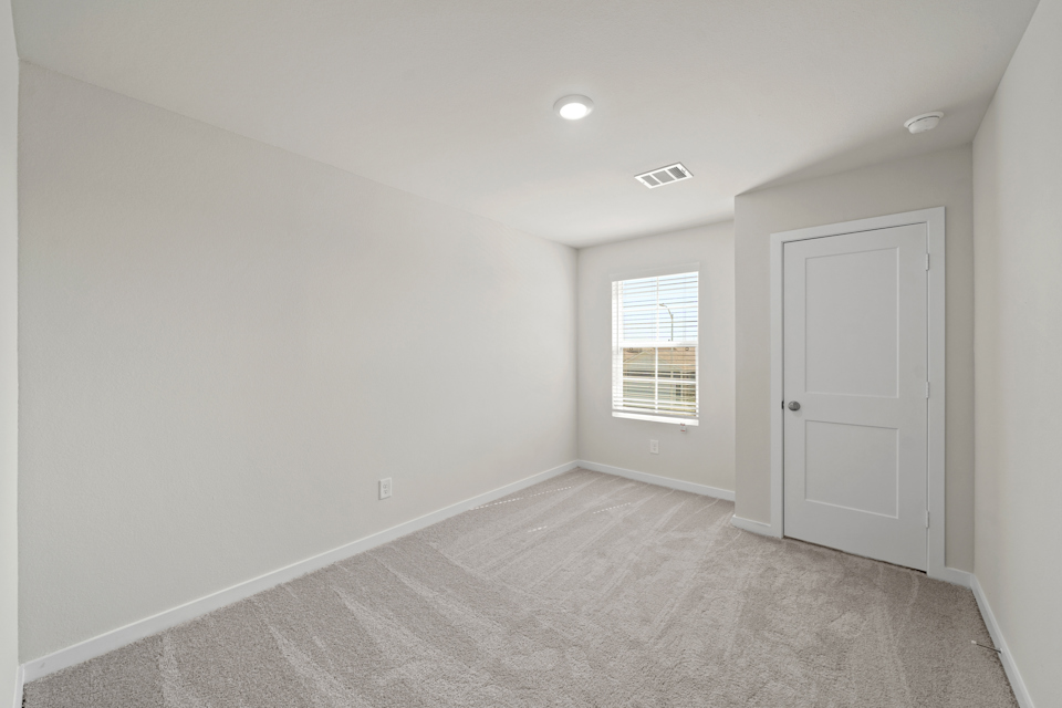 A room with white walls and a door.