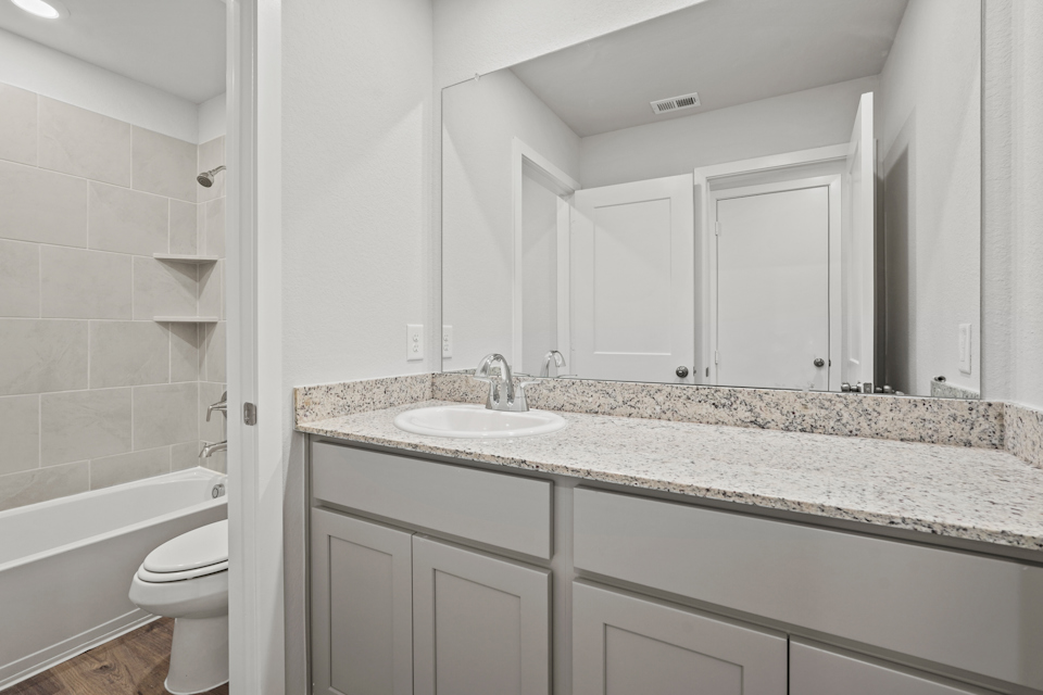 A bathroom with a marble countertop.
