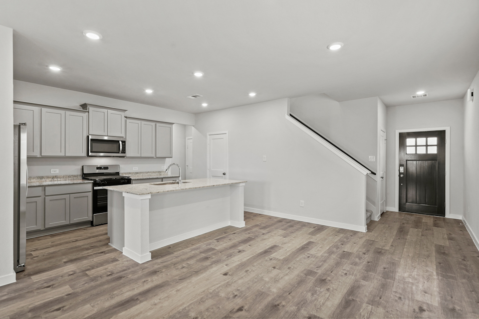 A kitchen with white cabinets.