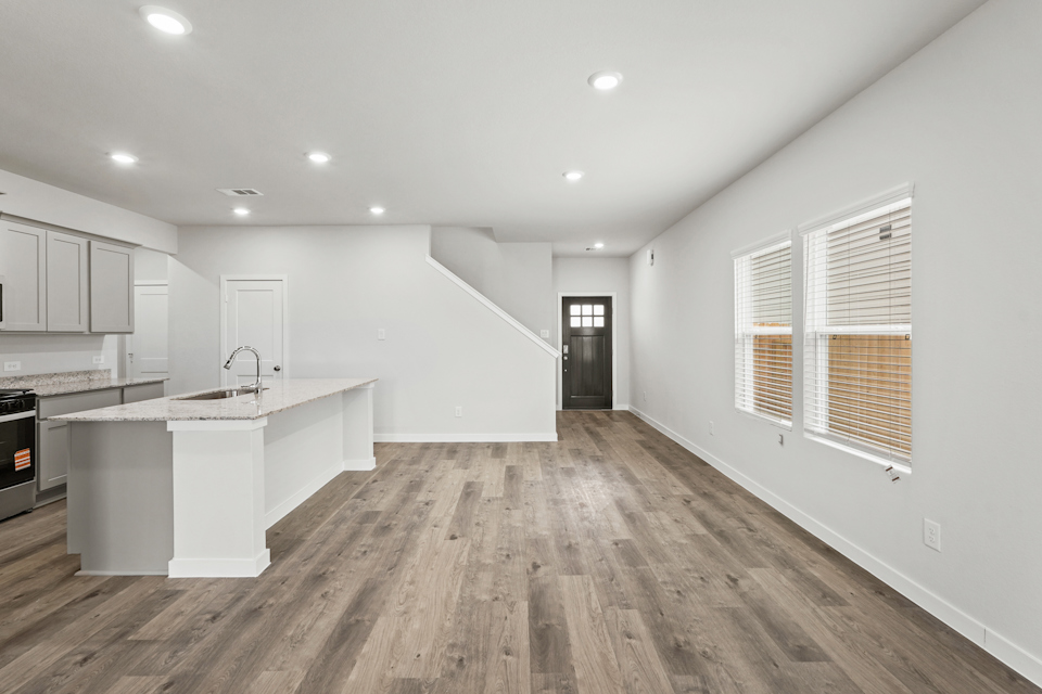 A kitchen with white cabinets.