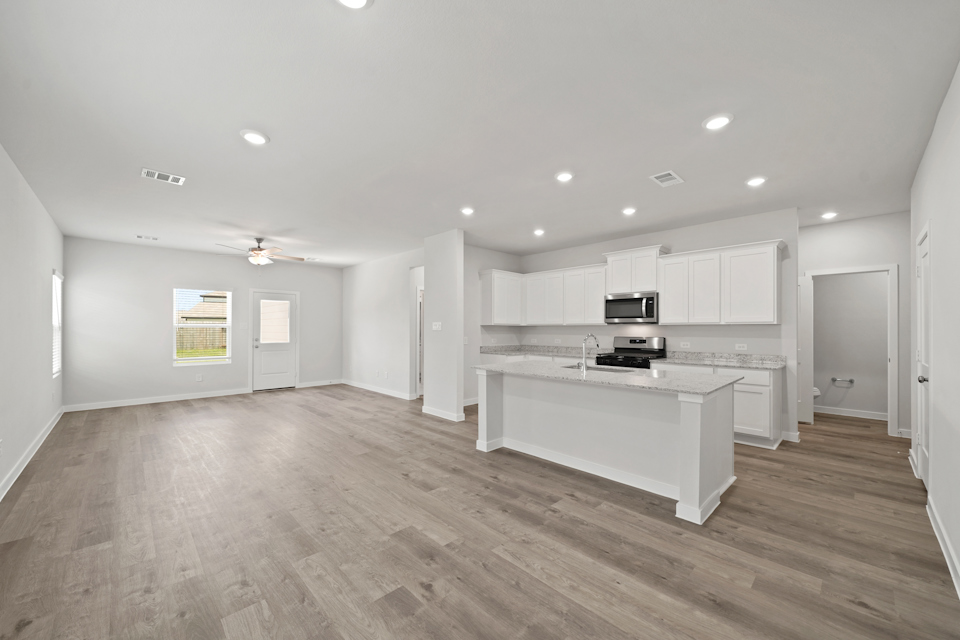 A large kitchen with white cabinets.
