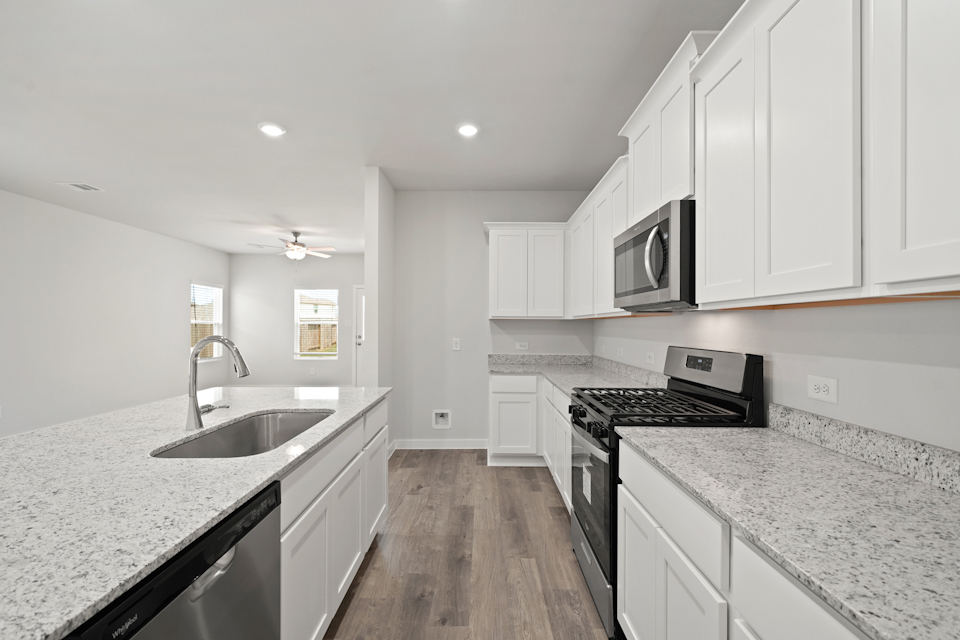 A kitchen with white cabinets.