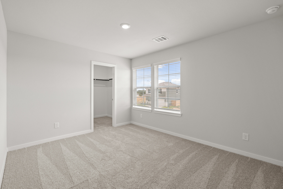 A room with a window and a door.