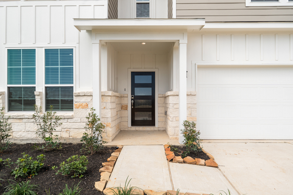 A garage door and a white house.