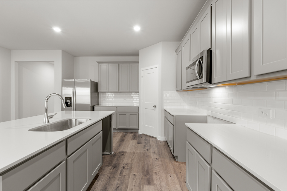 A kitchen with white cabinets.