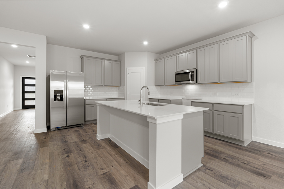 A kitchen with white cabinets.