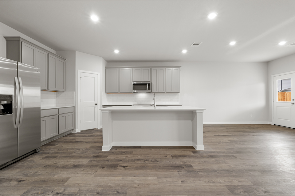 A kitchen with white cabinets.