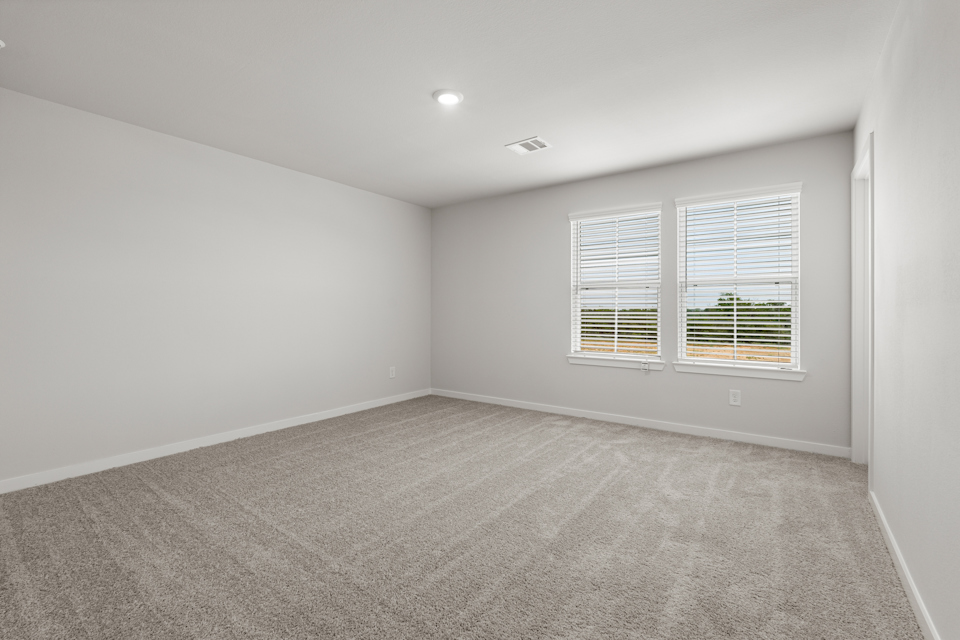 A room with a window and a carpet.