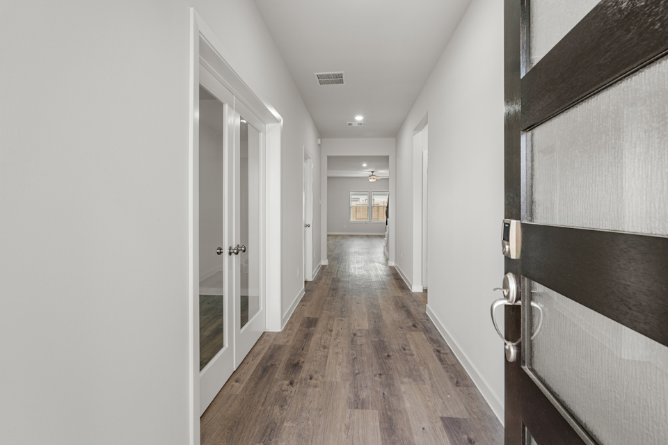 A hallway with white walls.