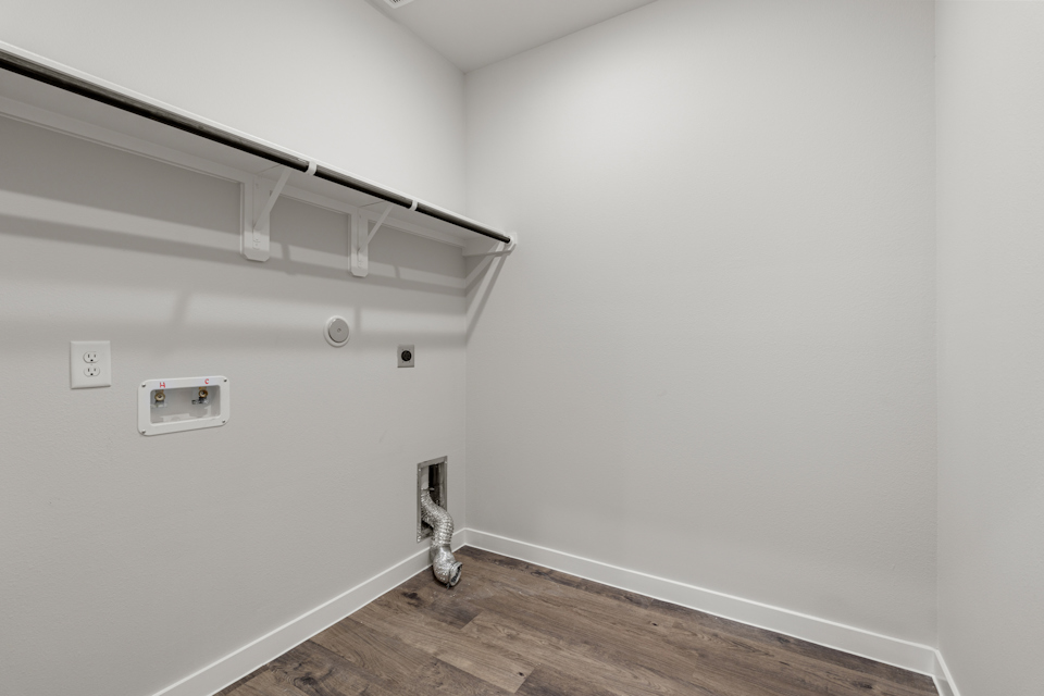 A white room with a wood floor.